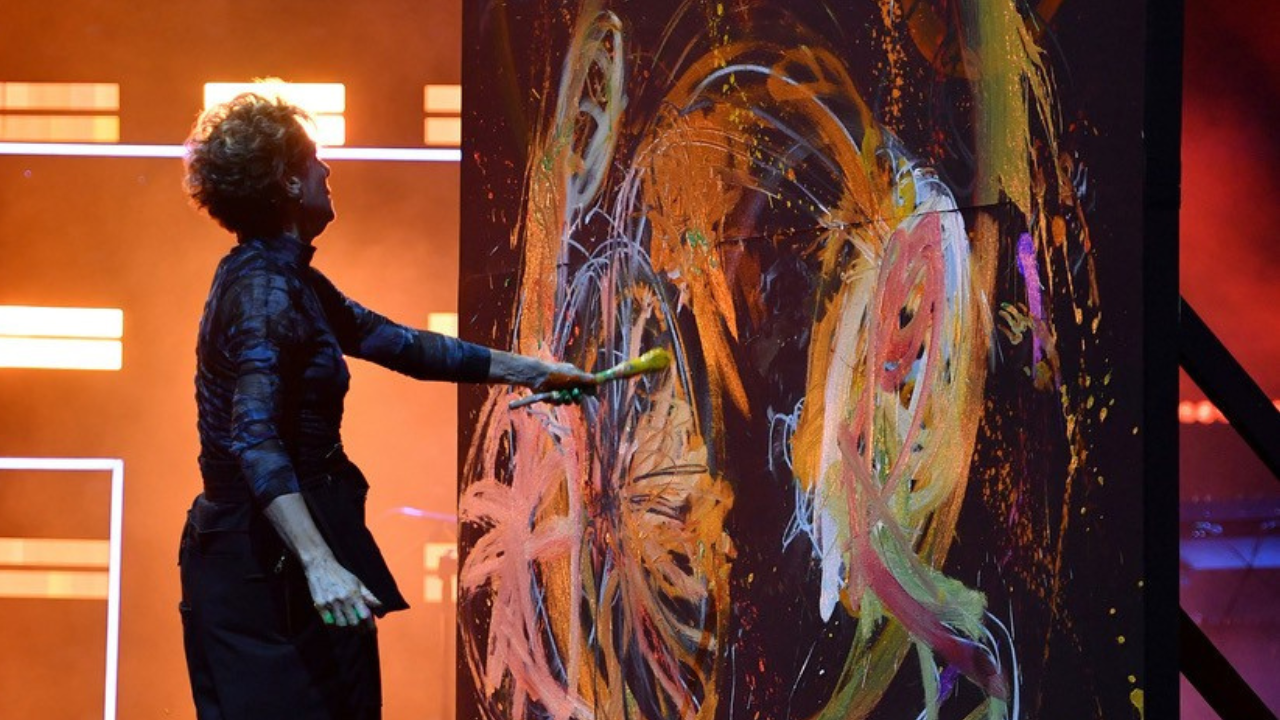 Rachel Gadsden is painting a large colourful artwork