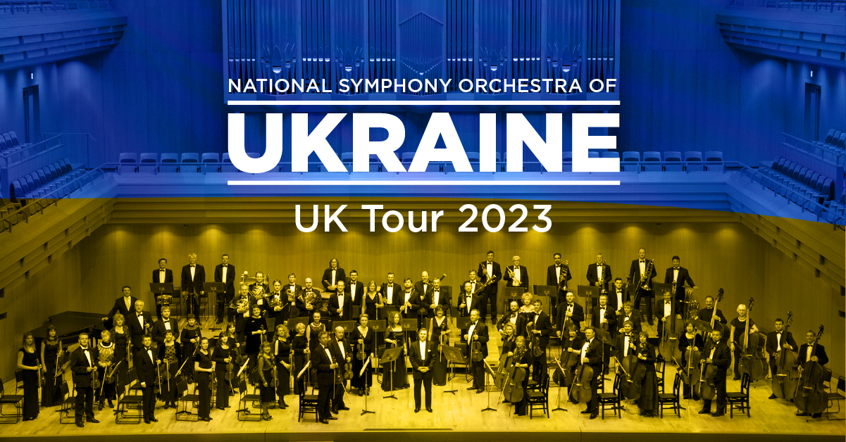 National Symphony Orchestra of Ukraine - UK 2023 tour. Picture of the full orchestra on a concert platform.